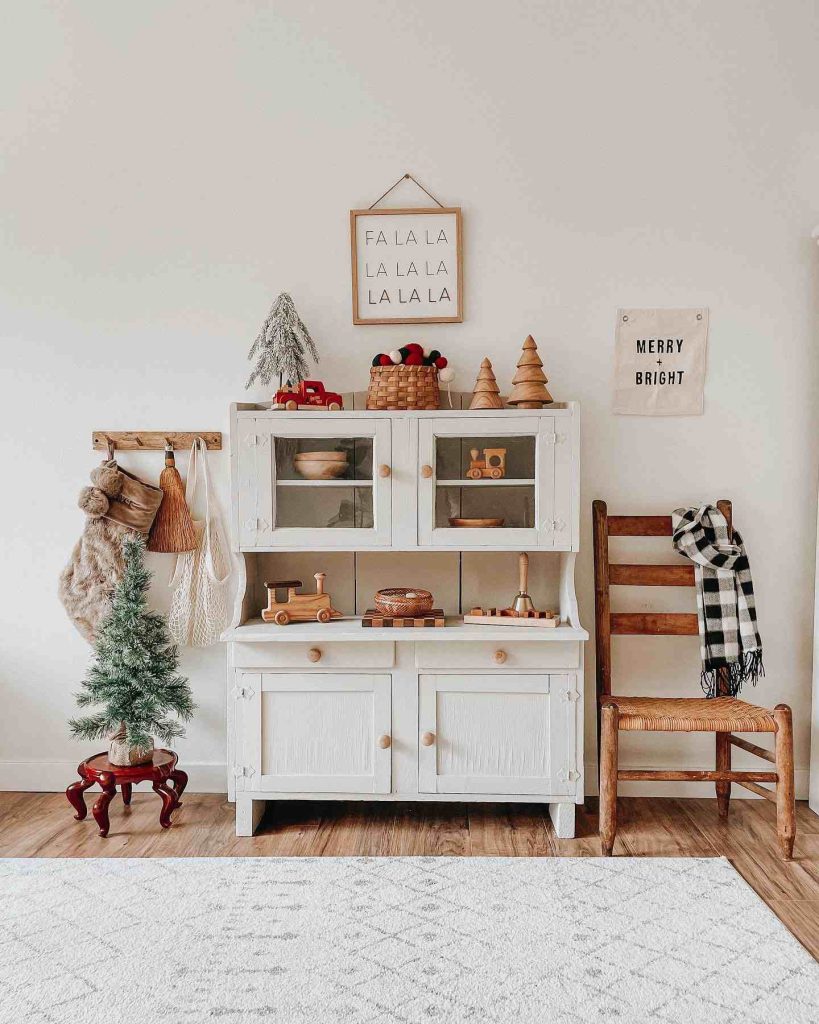 Rustic Christmas cabinet with festive decor and stockings.