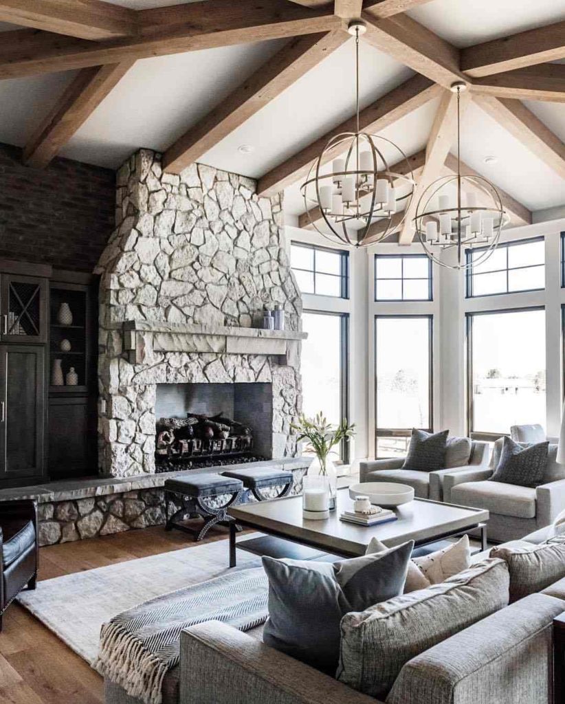 Grand living room with wood beams and stone fireplace