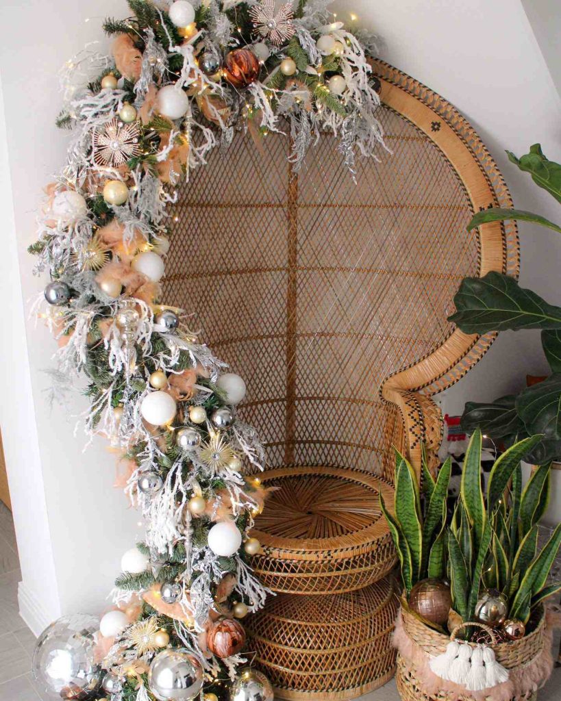 Woven chair with a festive garland and disco ball accents.
