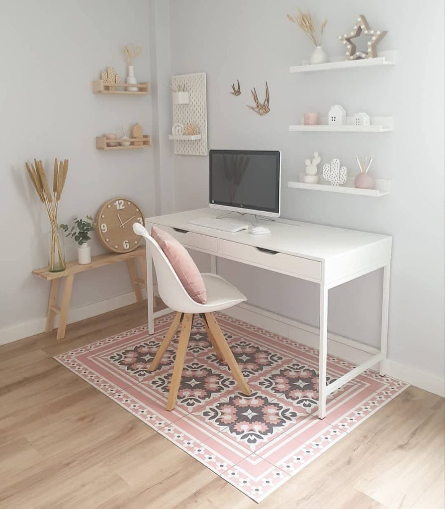 Soft minimalist desk with blush accents and plants.