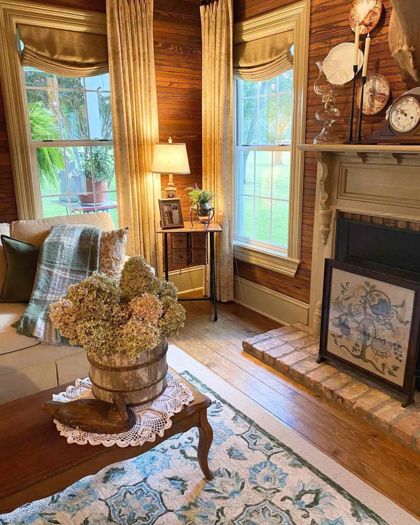 Vintage living room with wood paneling and dried flowers