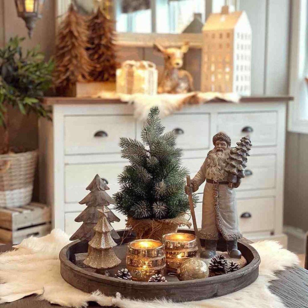 Tray with candles, a mini tree, and vintage holiday decor.
