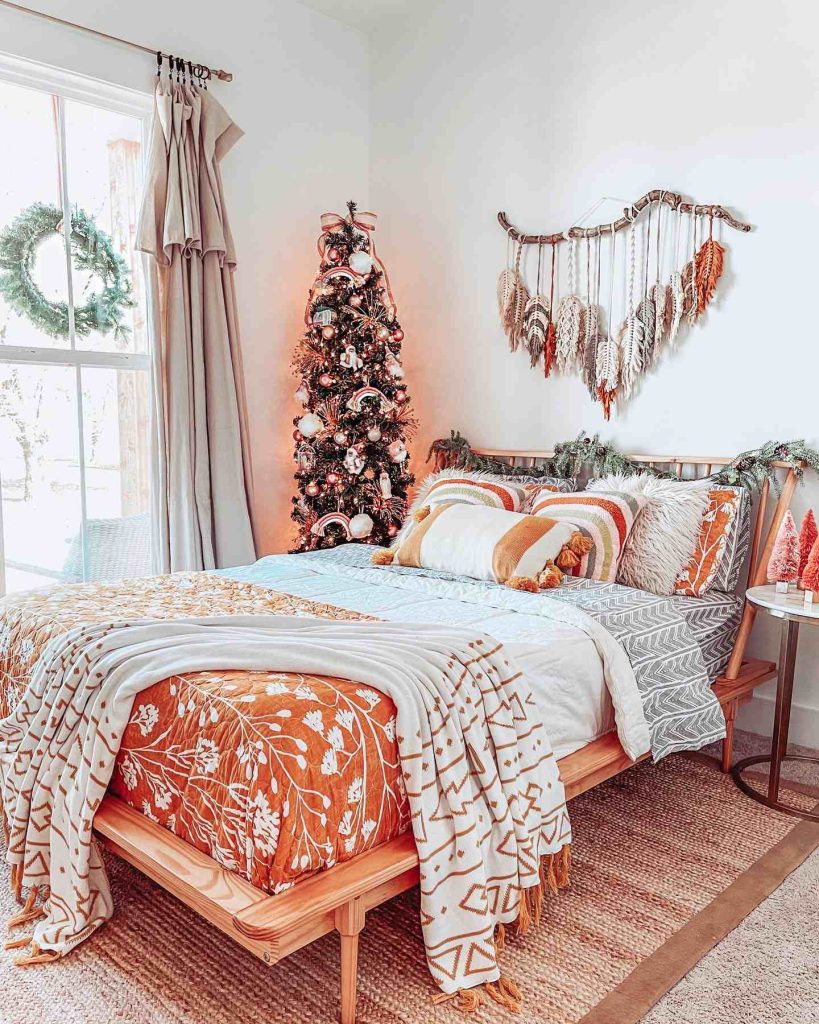 Bedroom with a slim tree, macramé, and cozy bedding.
