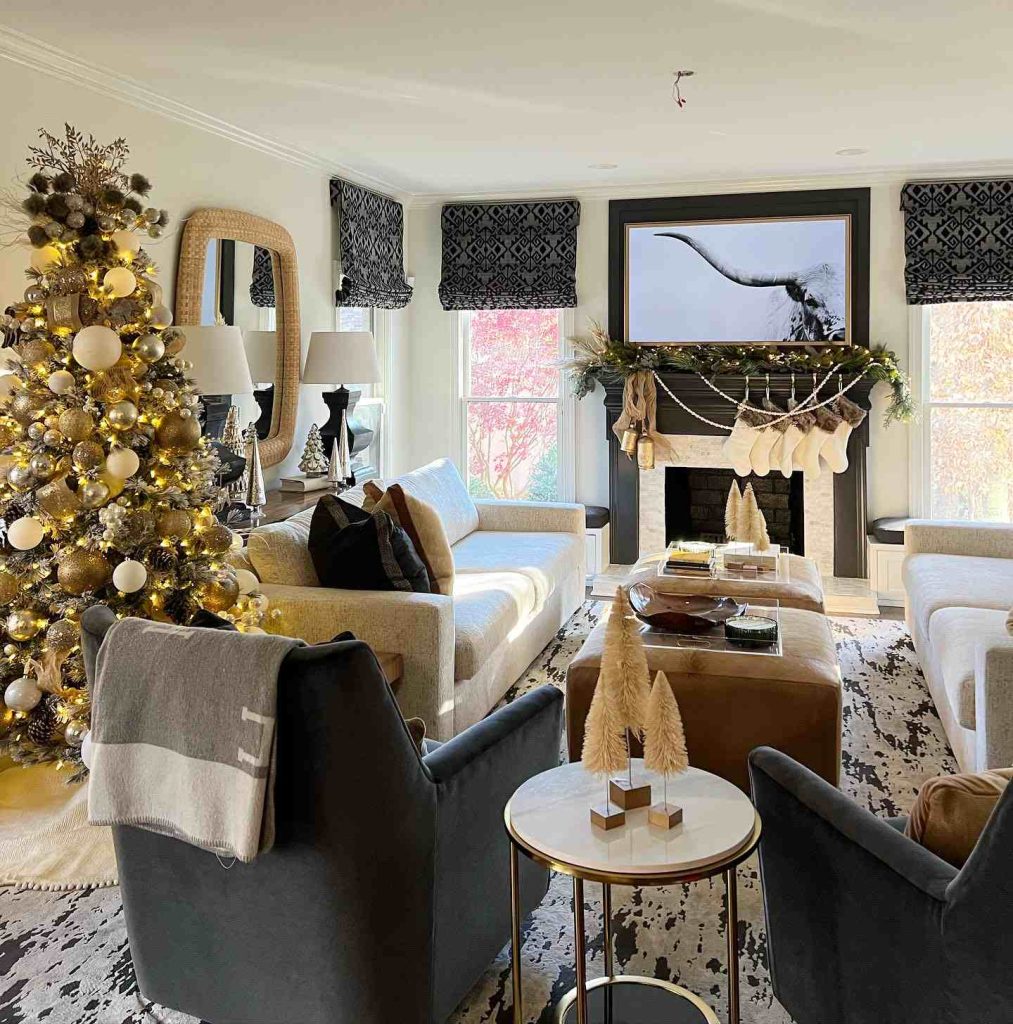 Elegant living room with a gold tree and mantle garland.
