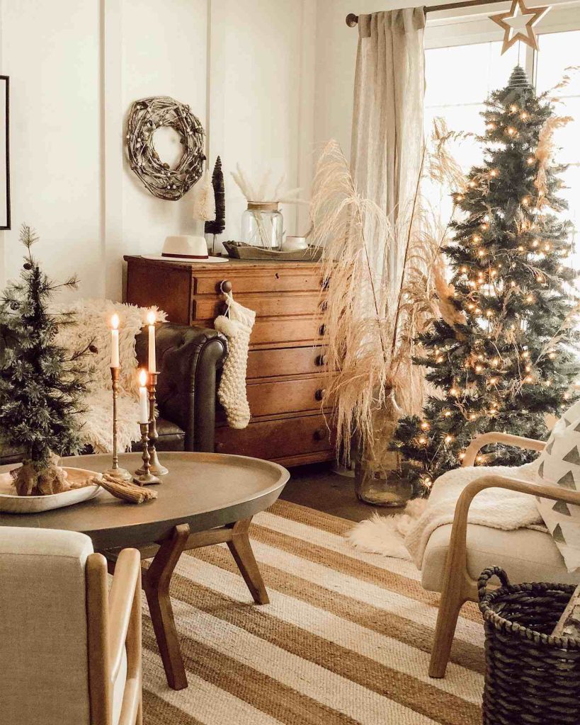 Living room with pampas grass and a lit Christmas tree.
