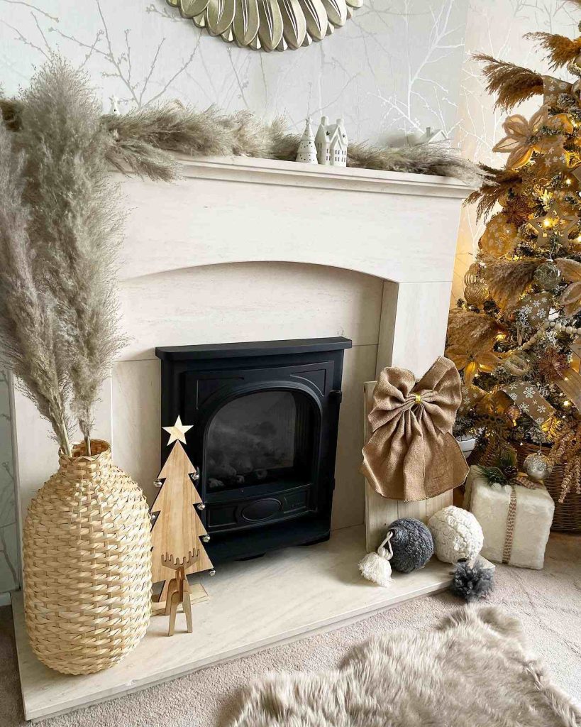 Neutral fireplace with pampas grass and holiday gifts.
