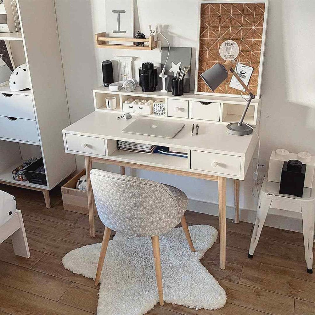 Scandinavian-style desk with a fluffy rug and storage.