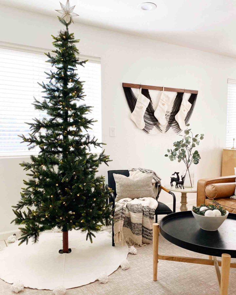 Minimalist tree with stockings and cozy boho throws.
