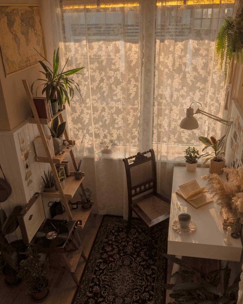 Vintage-inspired workspace with lace curtains and soft lighting.