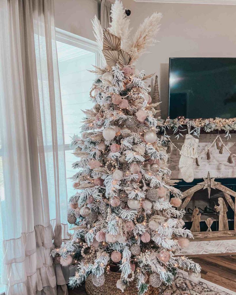 Frosted tree with pink accents and pampas grass topper.