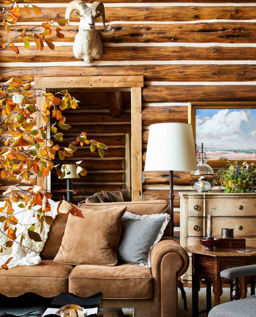 Log cabin-style living room with autumn decor