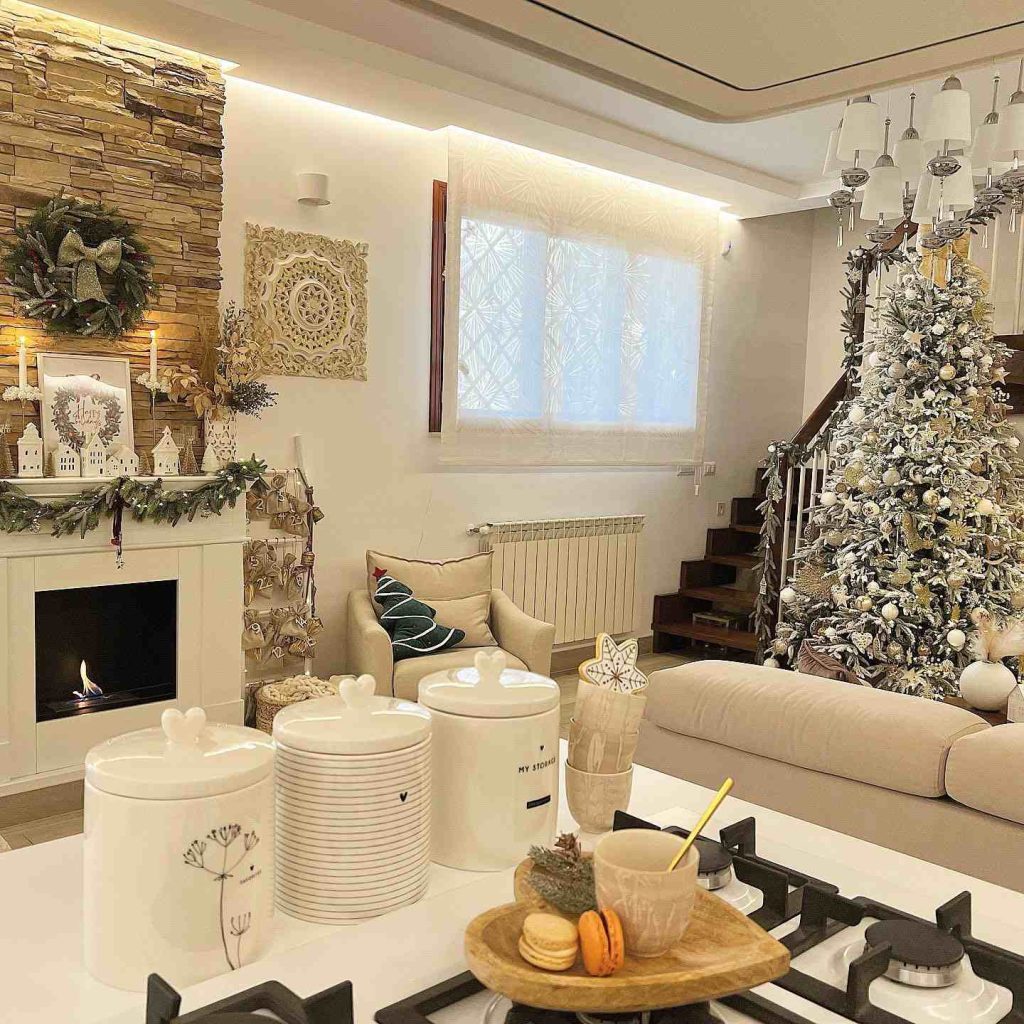 Cozy living room with a decorated mantle and frosted tree.
