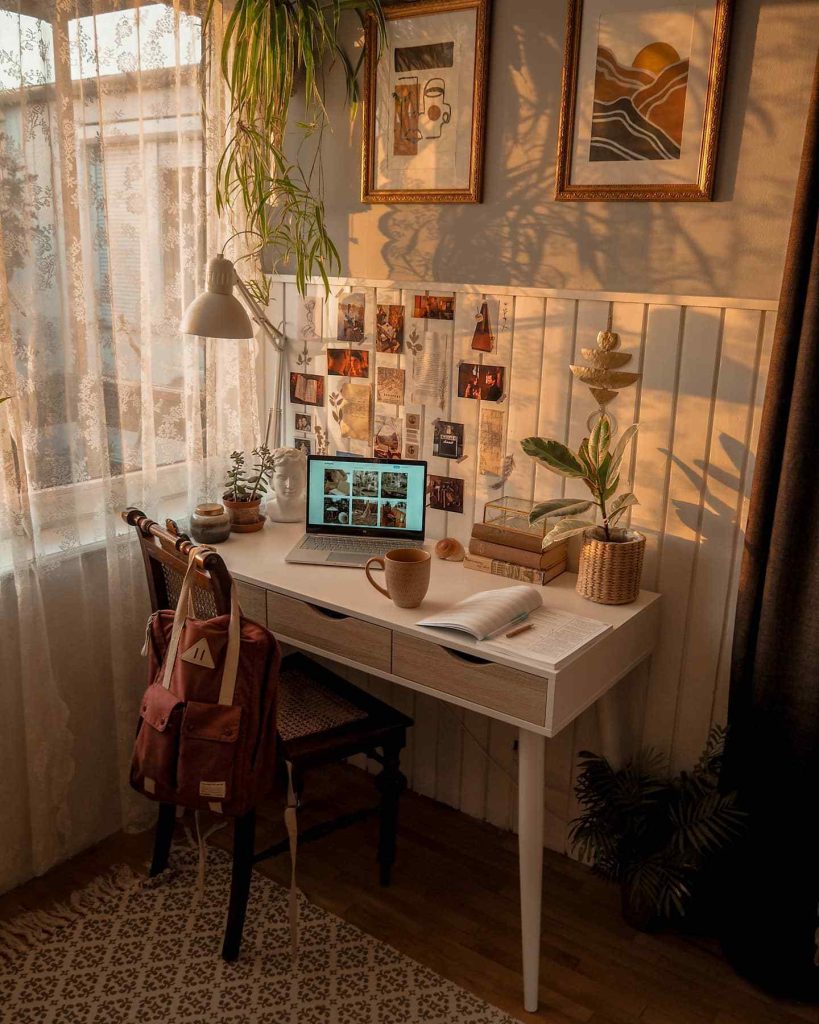 Golden hour desk with laptop, books, and coffee.