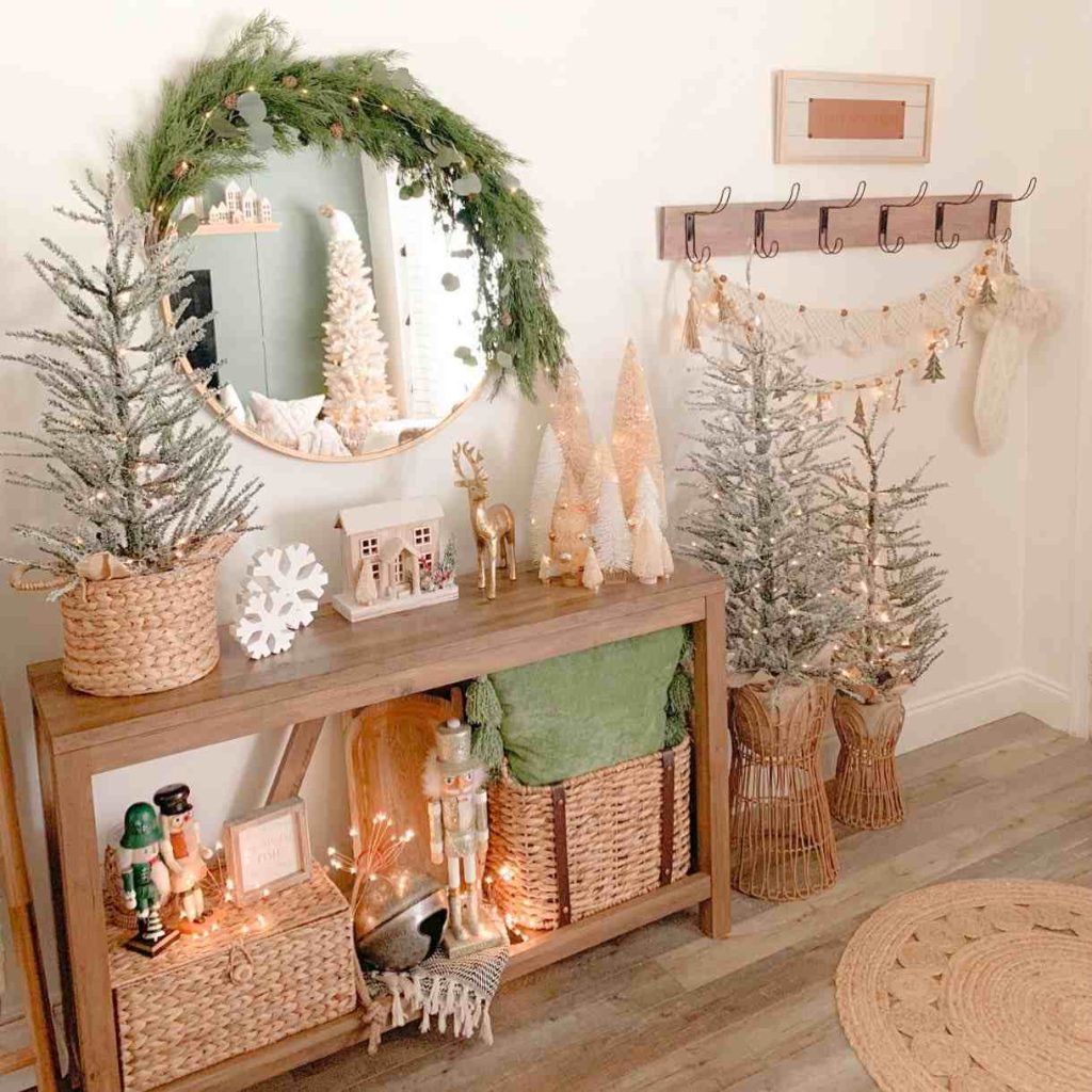 Entryway with frosted mini trees and festive decorations.
