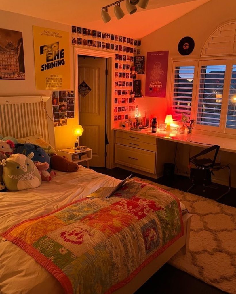 Moody bedroom with dramatic lighting, polaroid wall, and nostalgic decor.