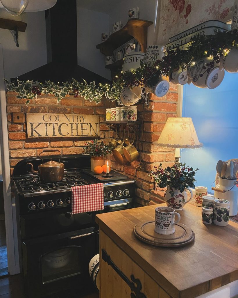 Cozy country kitchen with brick backsplash, vintage stove, and festive holiday decor.
