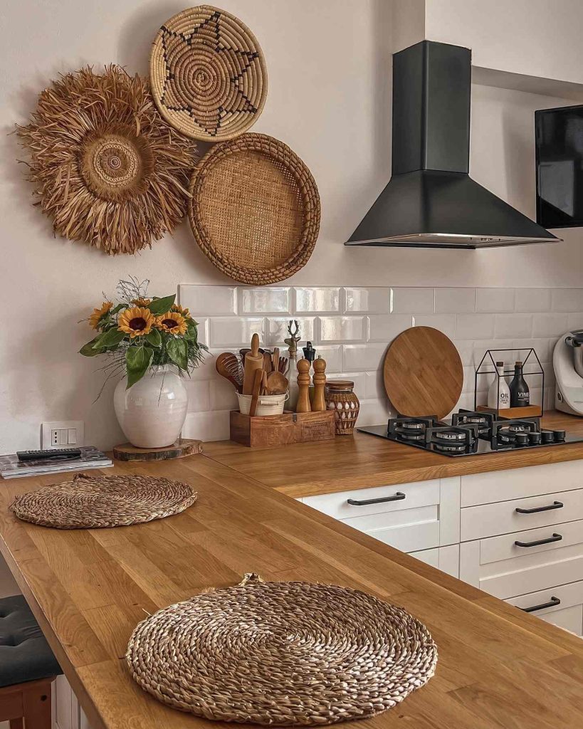 Rustic kitchen with woven baskets, sunflower arrangement, and natural wood countertops.
