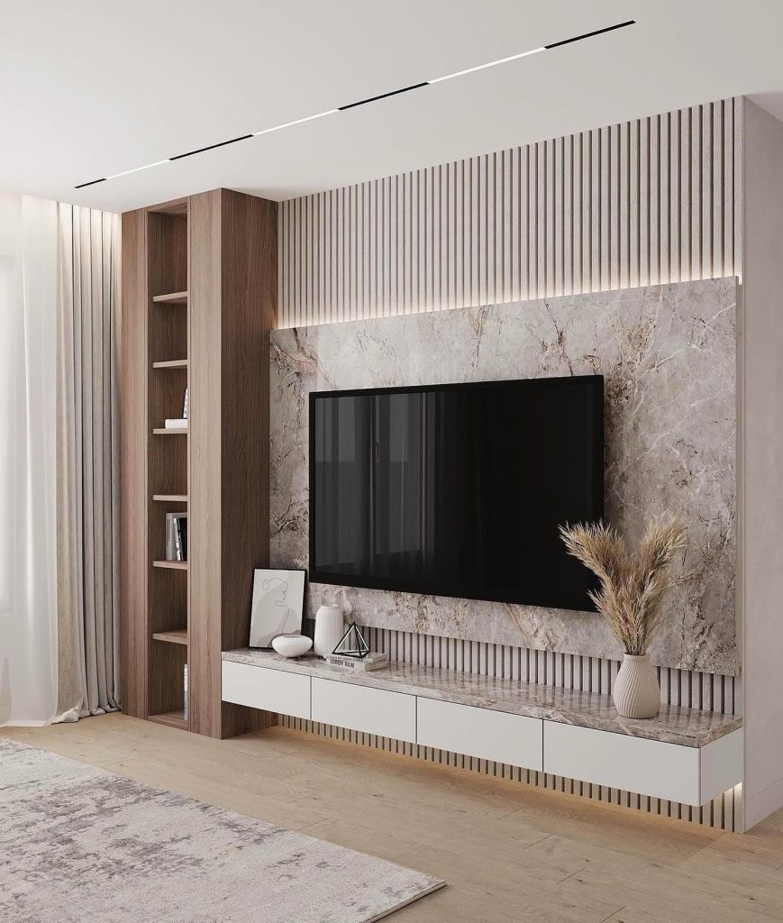 Marble and wood TV wall with soft lighting and modern furniture.
