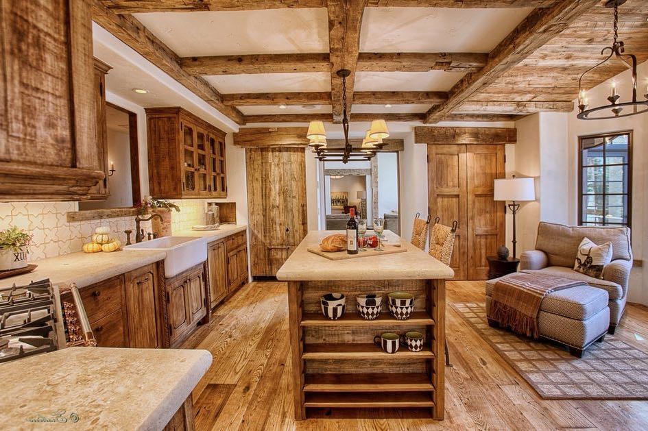 Warm and inviting kitchen with exposed wooden beams, farmhouse sink, and a cozy seating area.
