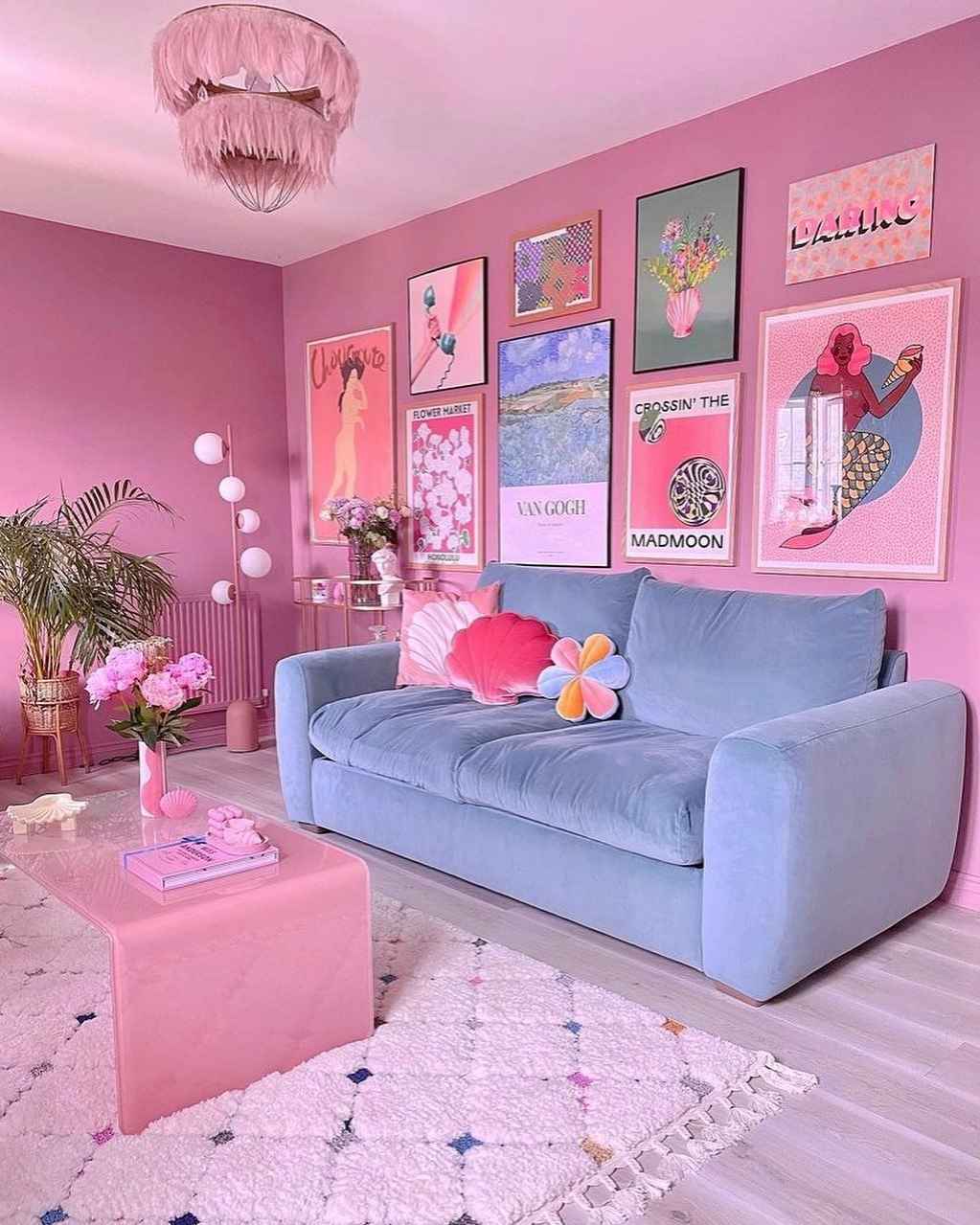 Pastel pink and blue living room with seashell pillows and dreamy wall art.
