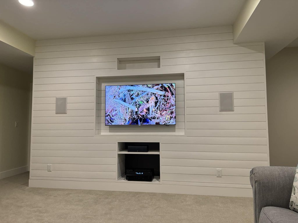 Shiplap TV wall with recessed display area and farmhouse-inspired design.