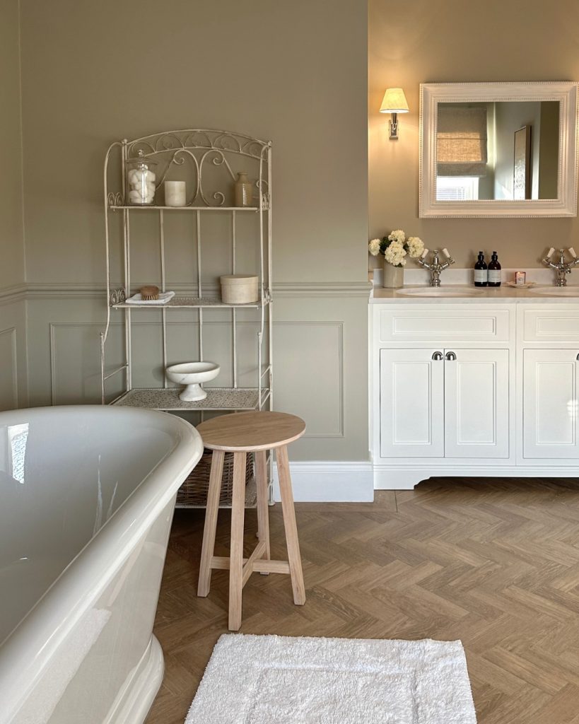 Classic bathroom with a freestanding tub and vintage shelving.
