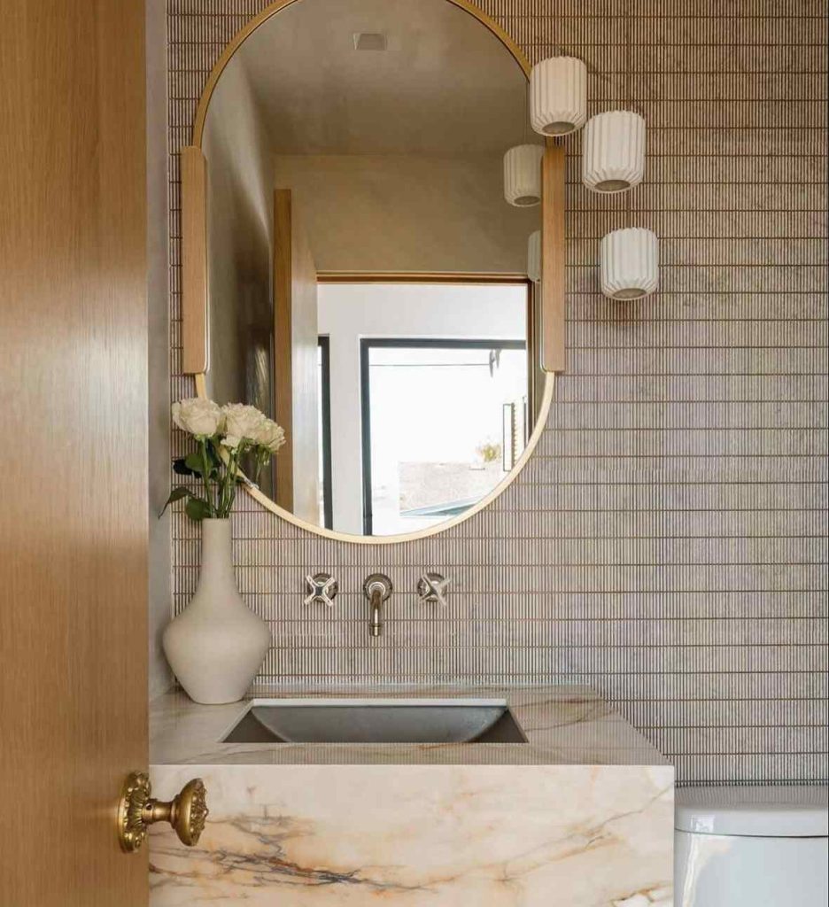 Modern marble sink with gold accents and soft lighting.
