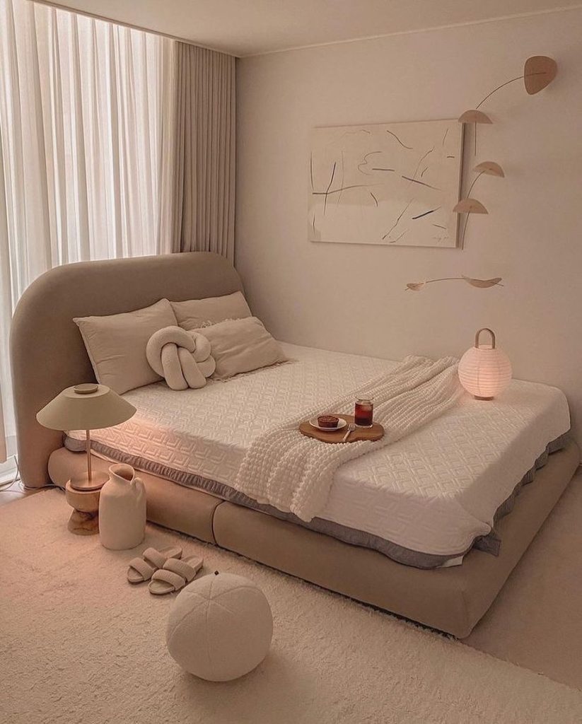 Minimalist neutral bedroom with soft textures and ambient lighting.