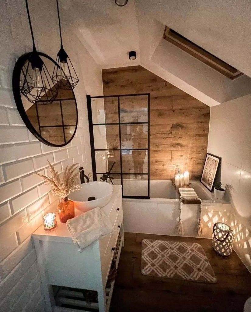 Rustic bathroom with candles, wood paneling, and industrial lighting.
