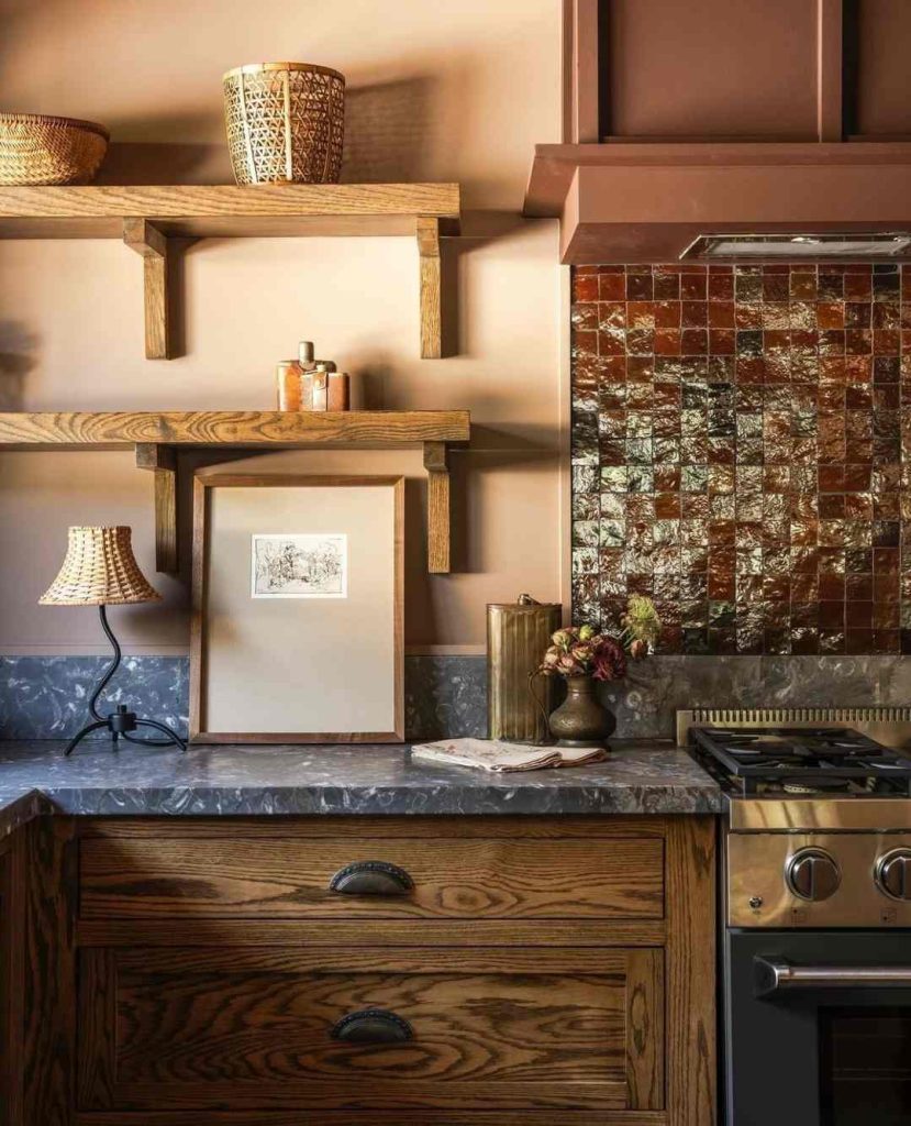 Cozy kitchen corner with a warm tile backsplash, open wooden shelving, and earthy accents.
