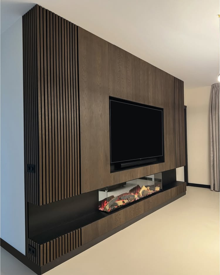 Open-concept living room with wood tones, recessed lighting, and a modern TV wall.
