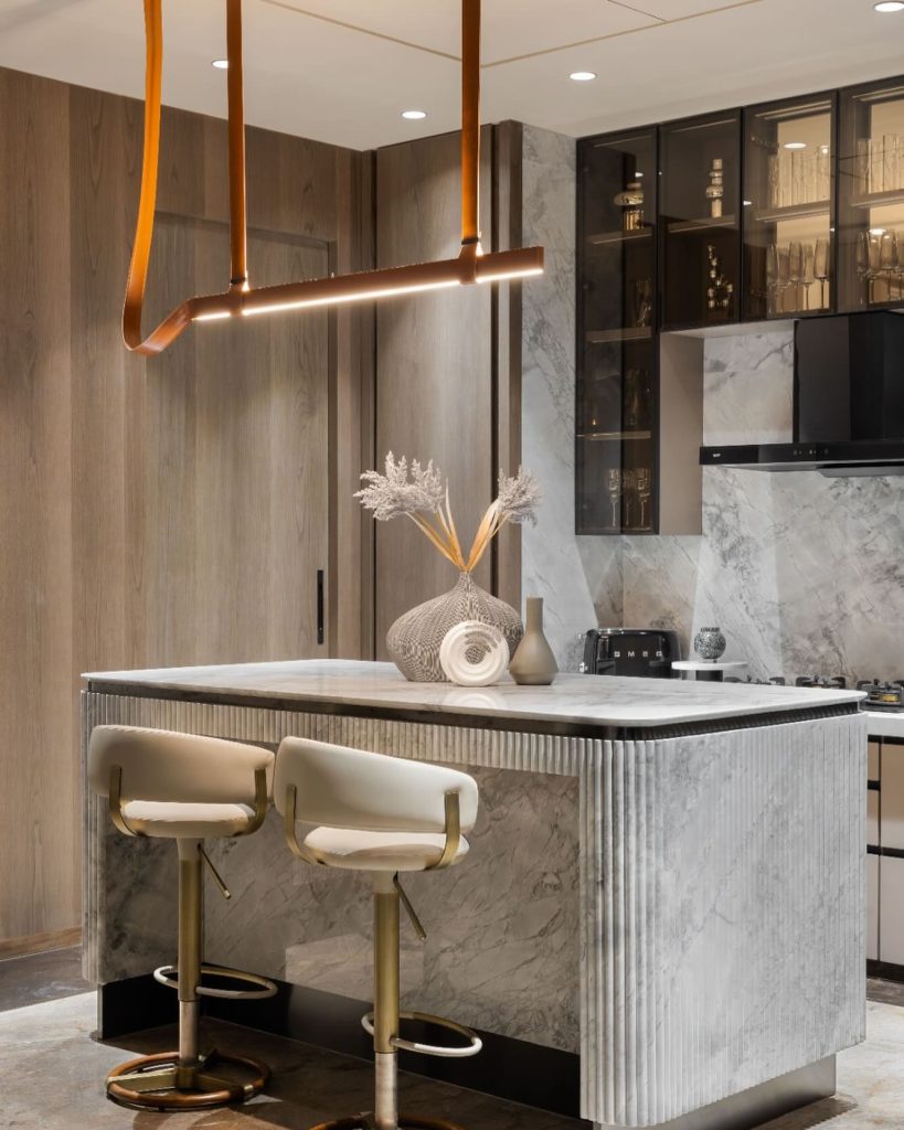 Marble island with chic bar stools in a modern open kitchen.
