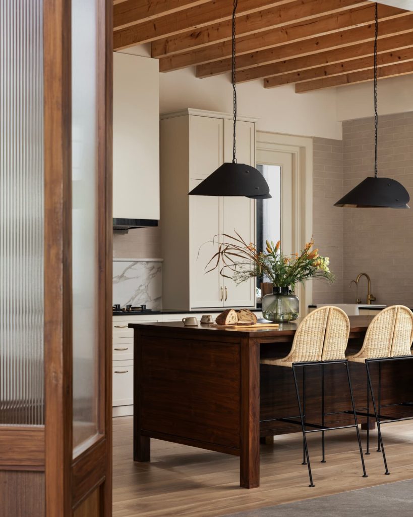 Neutral-toned open kitchen with functional storage solutions.
