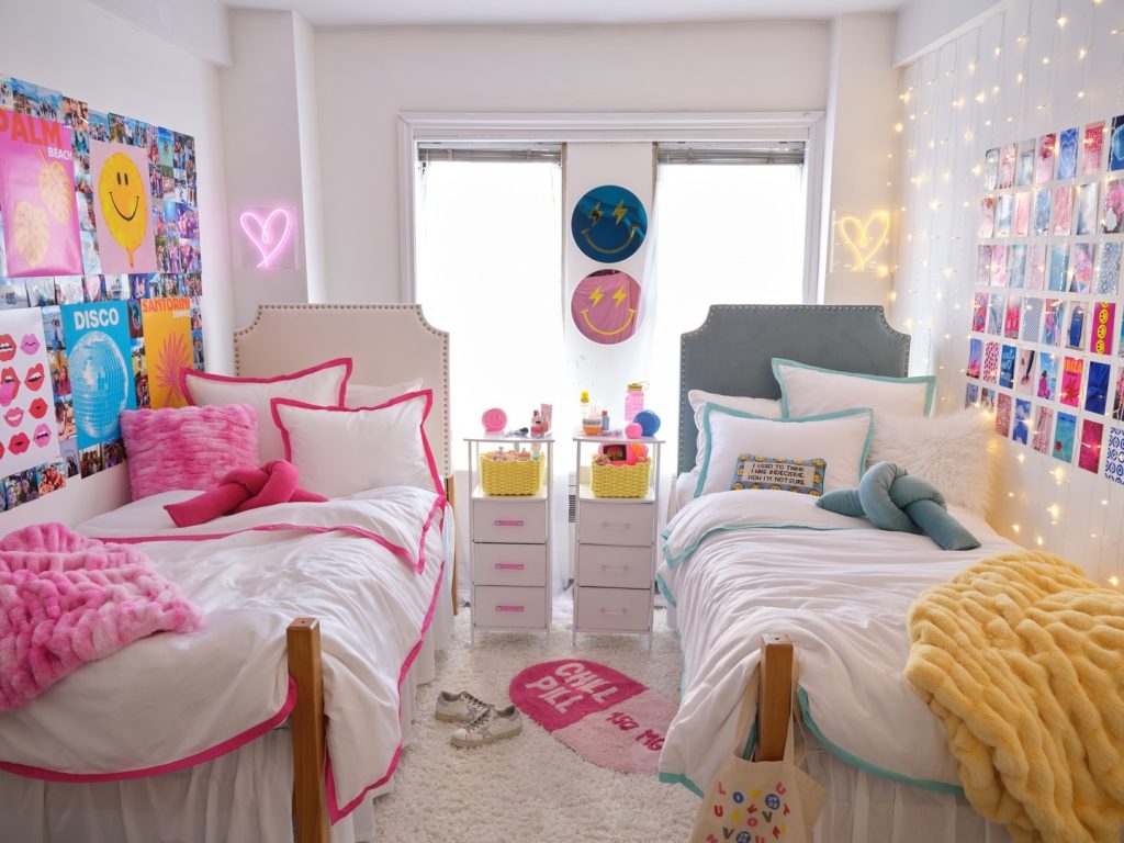 Playful dorm with neon signs, colorful posters, and contrasting bedding in vibrant hues.
