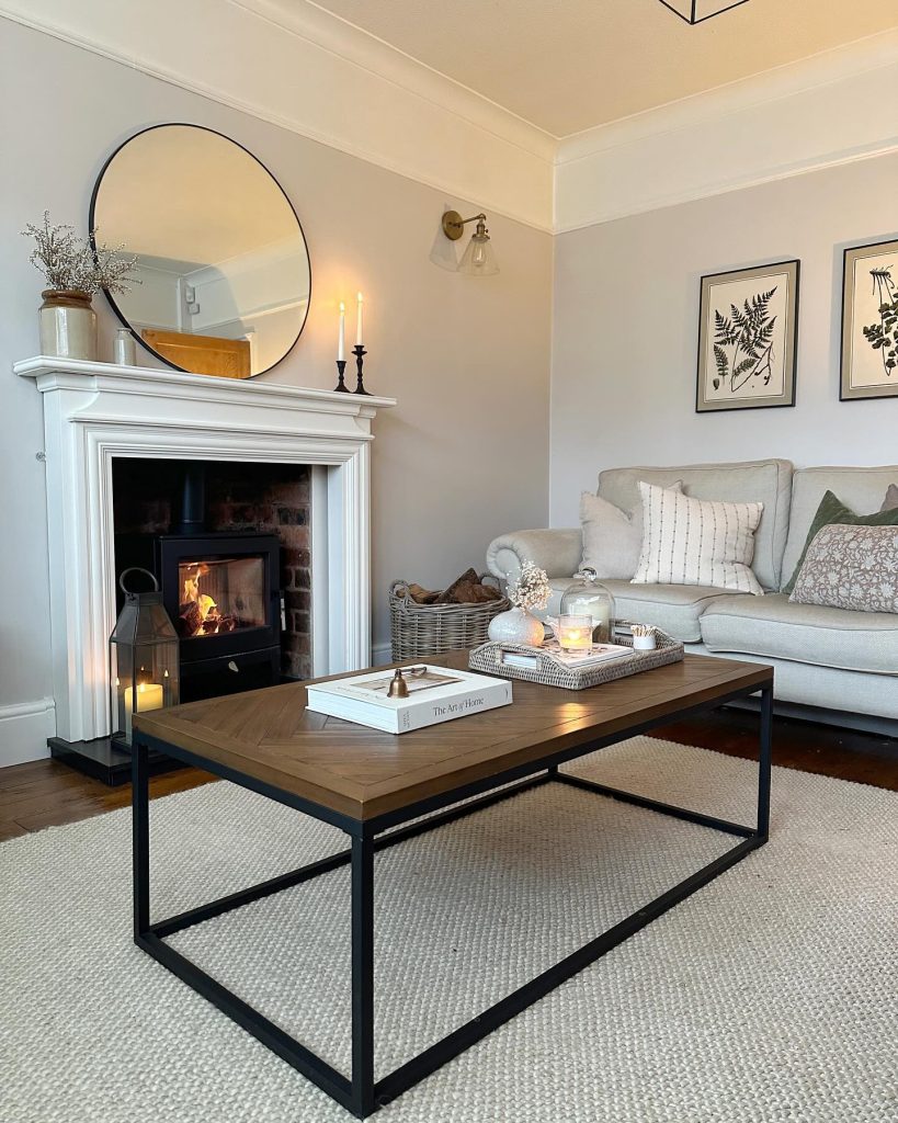 Neutral-toned living room with a simple white fireplace and cozy decor.
