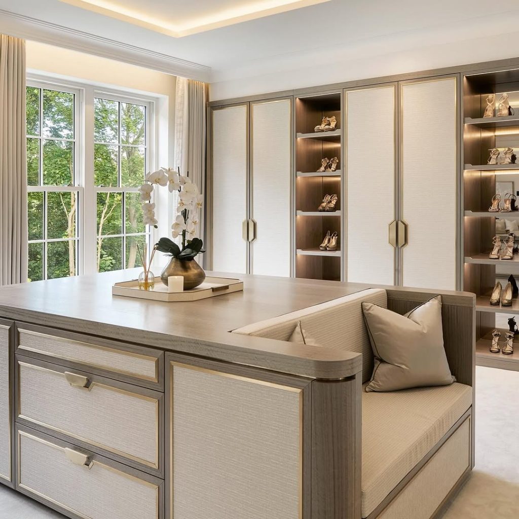 Luxurious dressing room with built-in shoe shelves and natural light.
