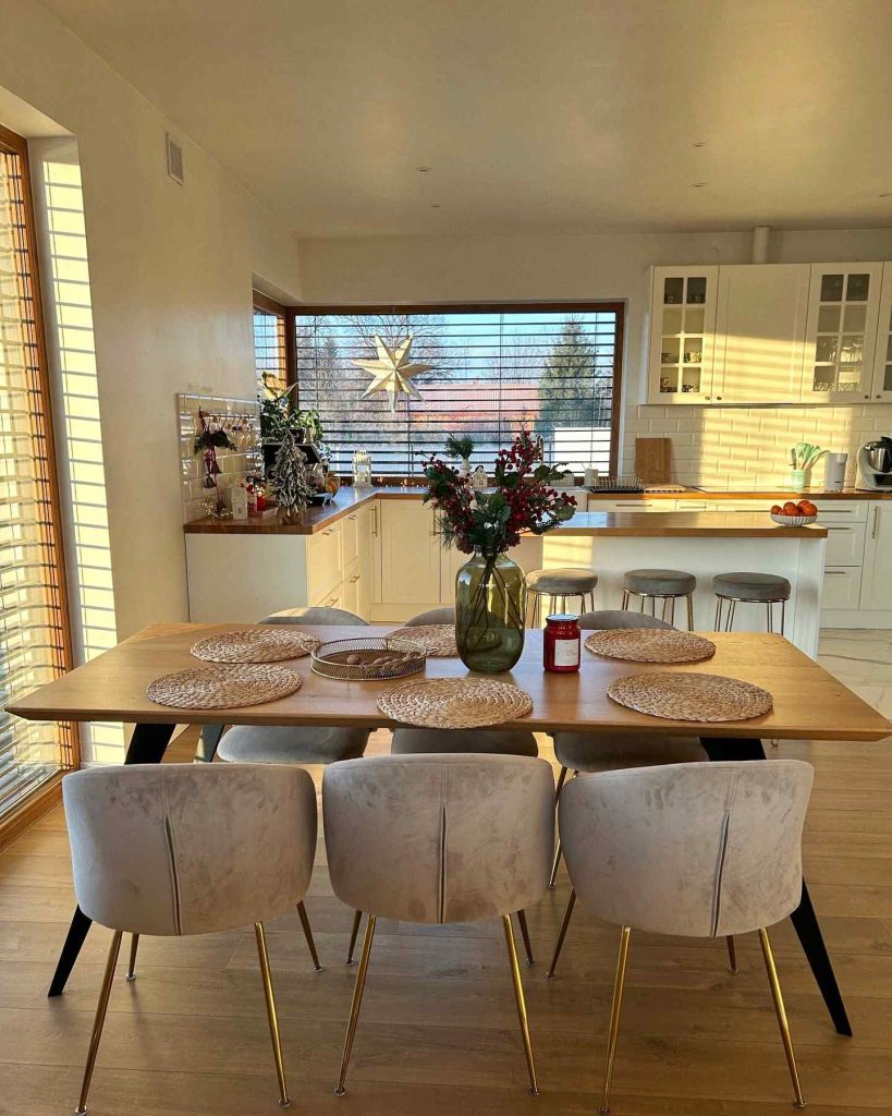 Festive kitchen-dining area with warm sunlight streaming in.
