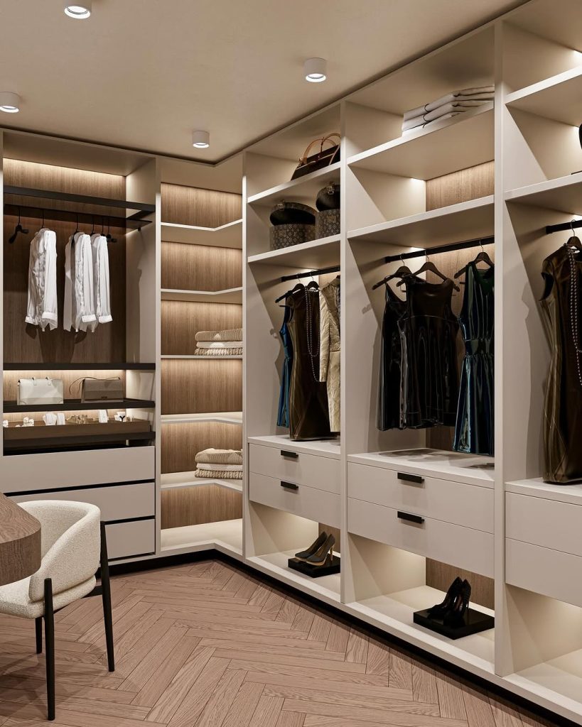 Walk-in closet with warm wooden accents and soft ambient lighting.
