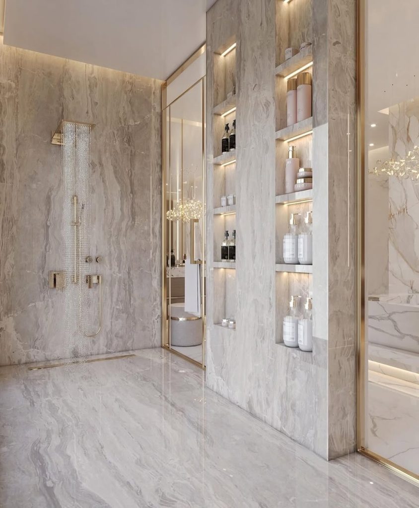 Spacious marble bathroom with rainfall shower and recessed shelves