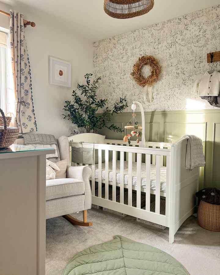 A serene baby nursery decor with soft textures and greenery.