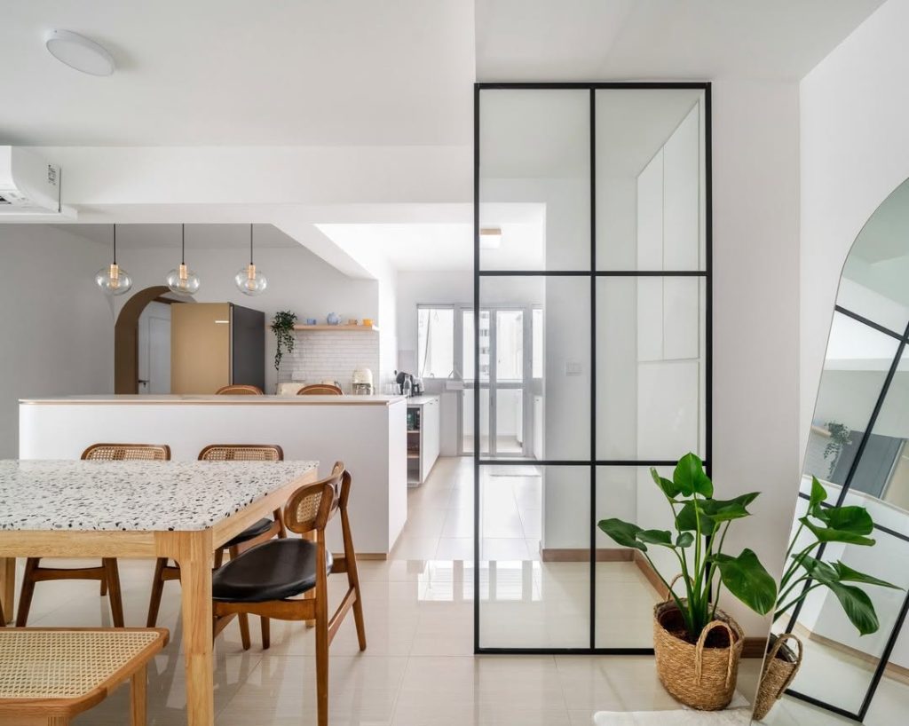 Minimalist kitchen with terrazzo dining table and glass partitions.
