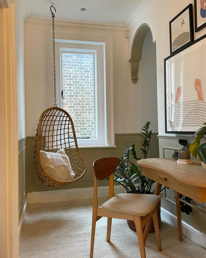 Wicker hanging chair in a small, calm corner with greenery.
