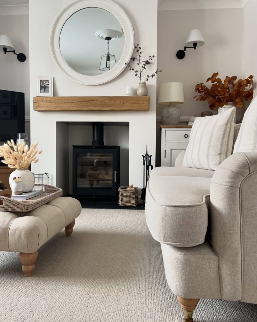 Luxurious marble fireplace with vibrant floral arrangements and gold mirror.
