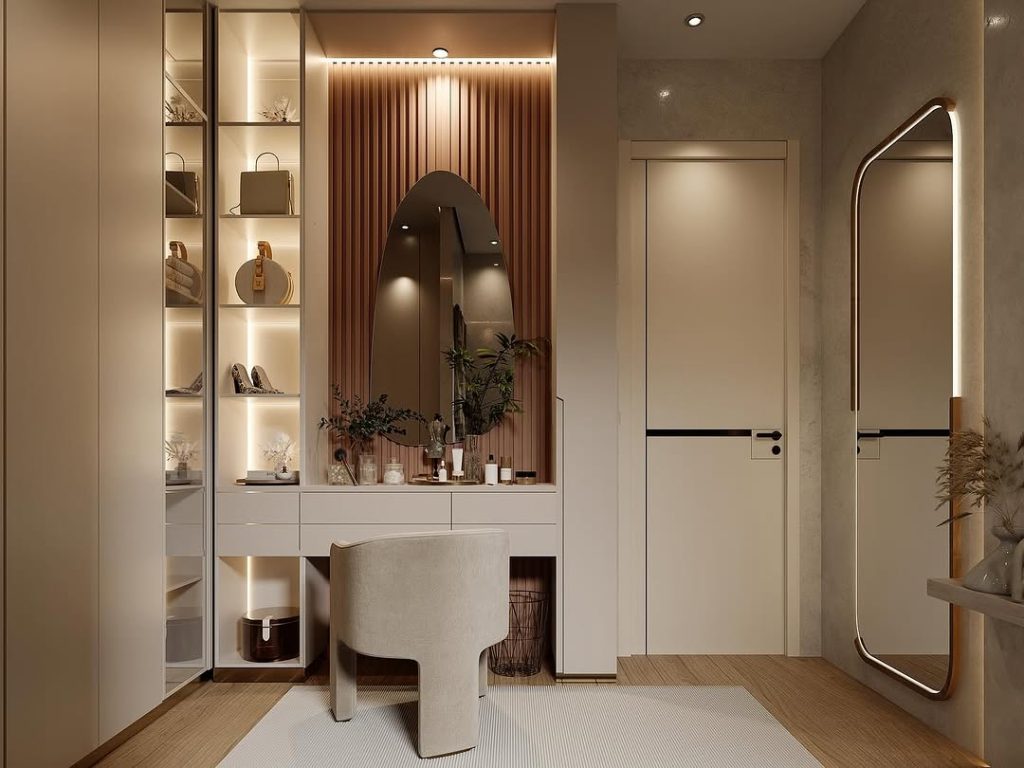 Warm-toned dressing room with arched mirror and illuminated shelves.
