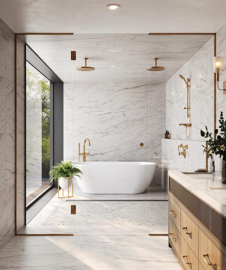 Bright marble bathroom with a freestanding tub and lush outdoor view.