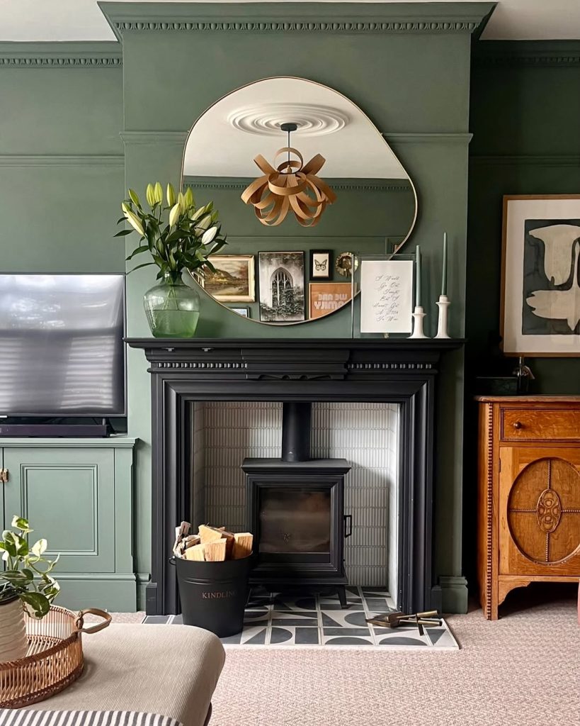 Minimalist white fireplace with a round mirror and neutral styling.
