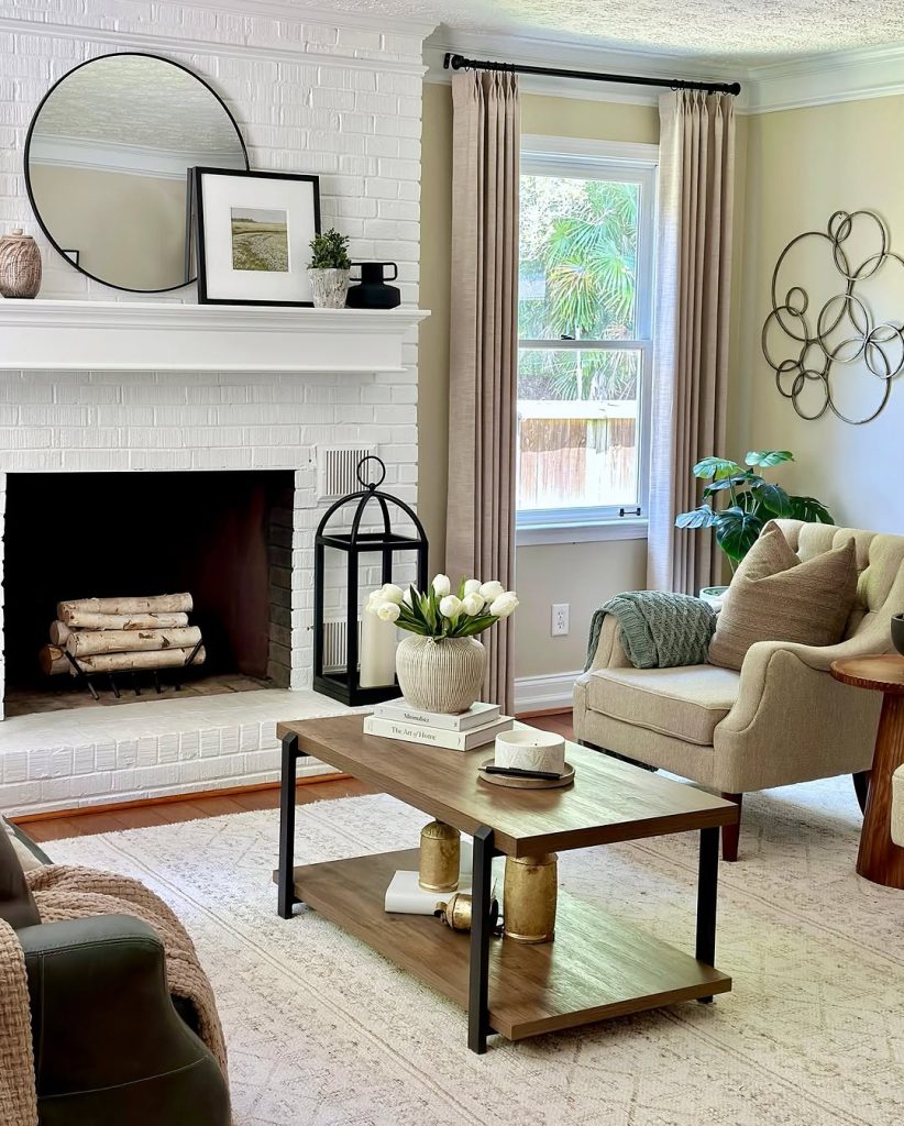 Charming brick fireplace with vintage decor and dried floral arrangements.
