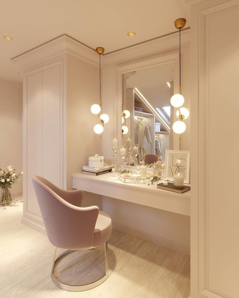 Soft glam vanity with blush tones, gold accents, and elegant lighting.
