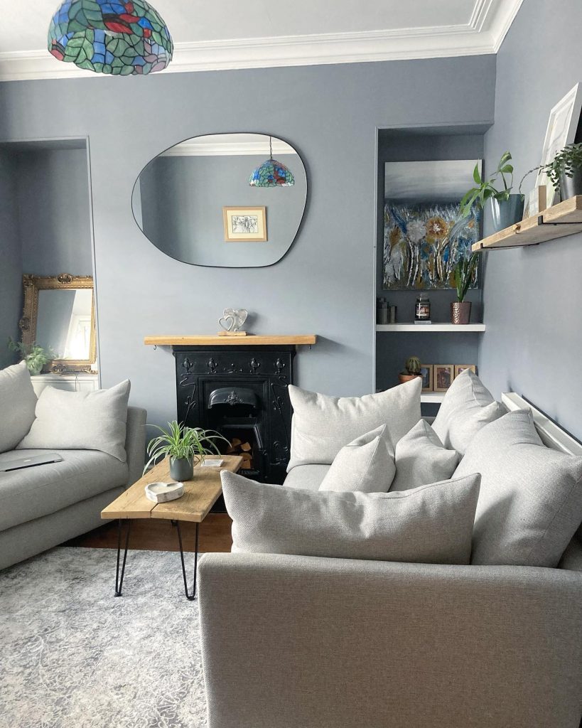 Moody grey living room with colorful stained-glass lights.
