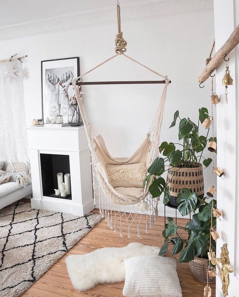 Boho hammock swing surrounded by greenery and soft textures.
